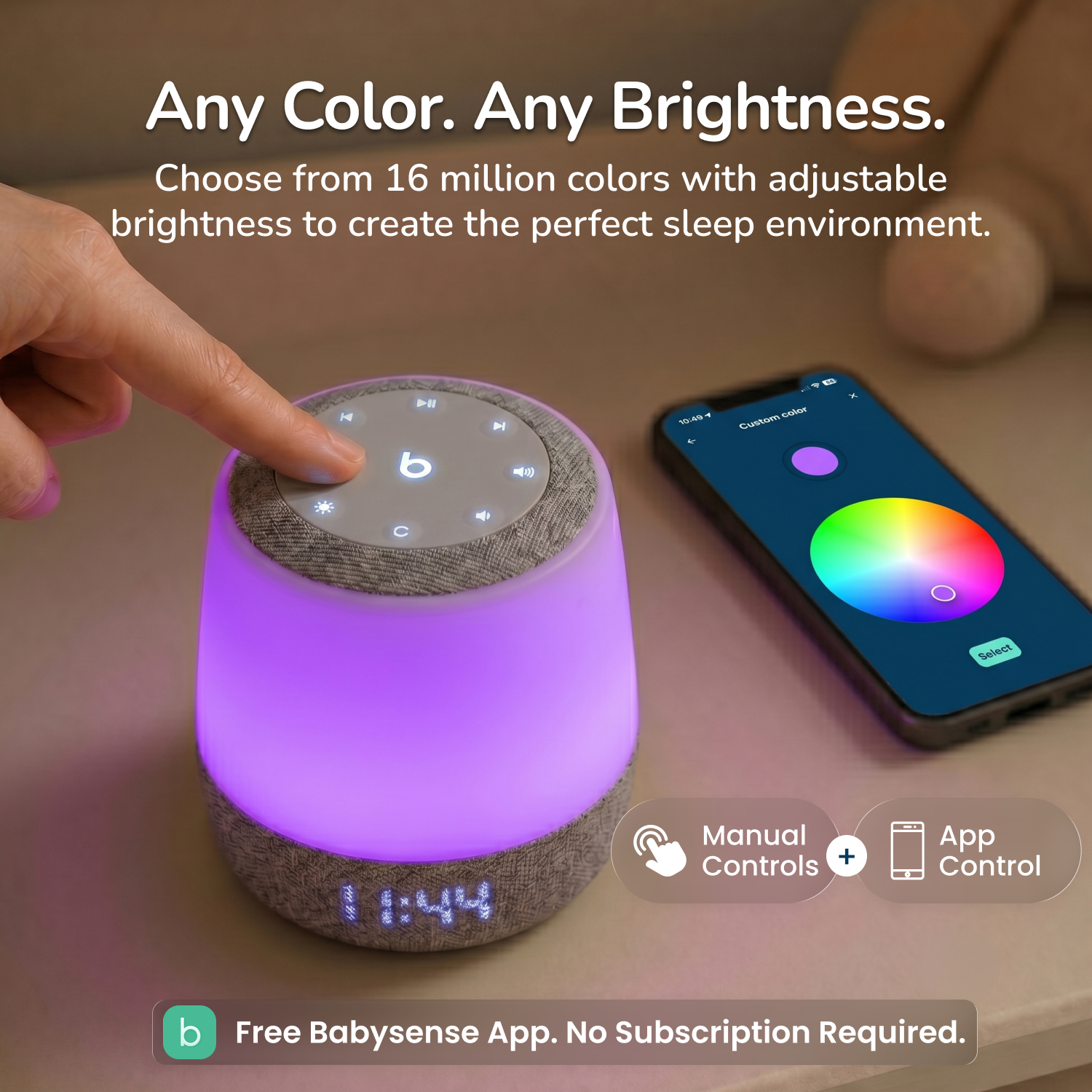 A baby sleep lamp with a textured gray fabric base and top, emitting a purple glow, shown next to a smartphone displaying its companion app color wheel. A hand is touching the top of the lamp.