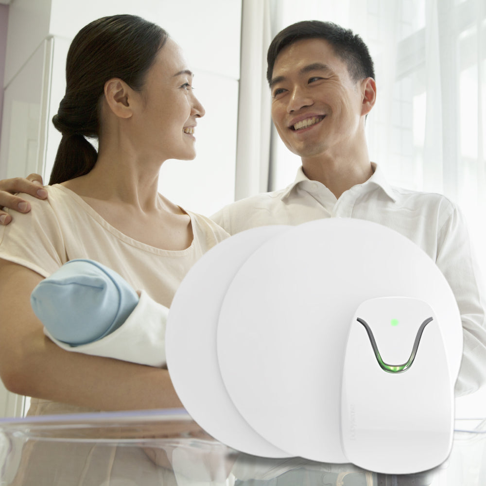 Man and woman sitting together with a white electronic device on a table between them.